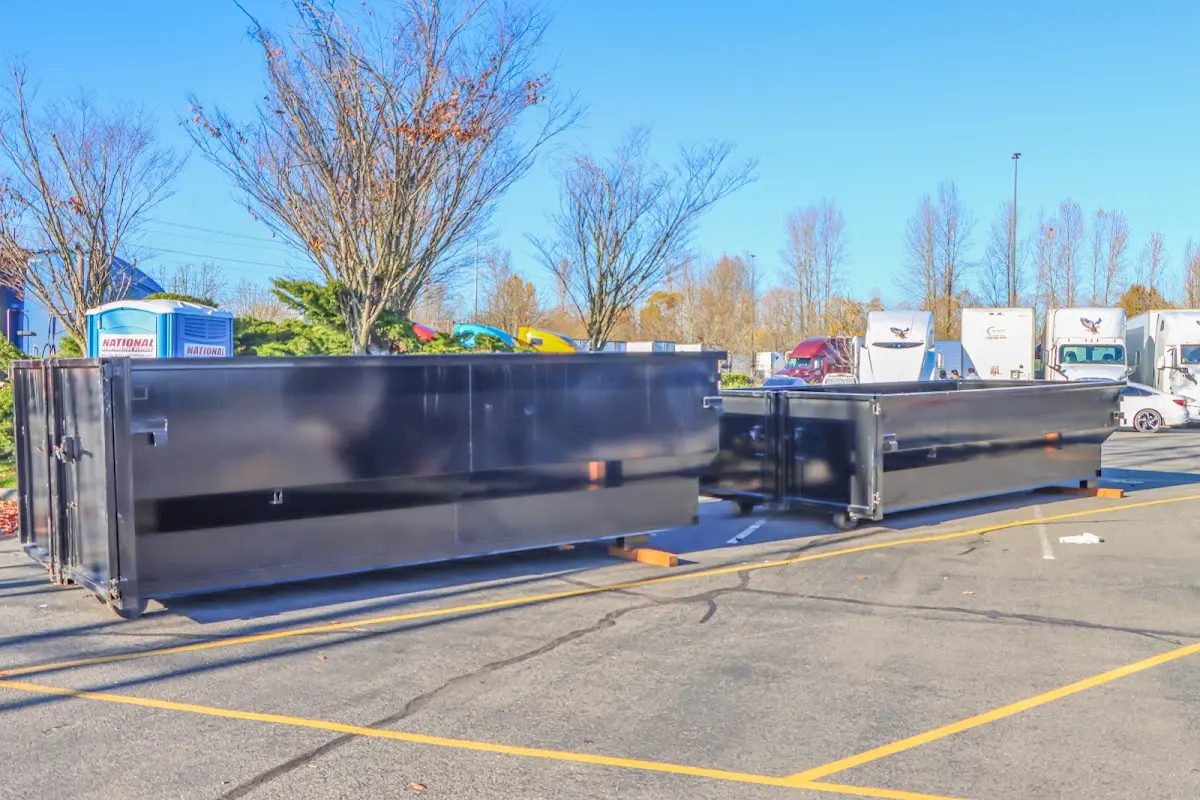 Professional dumpster rental service with roll-off container on residential driveway in Newburgh